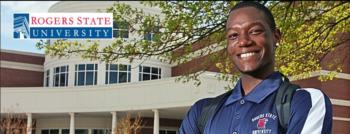 smiling student in front of building with 'rogers state university' logo