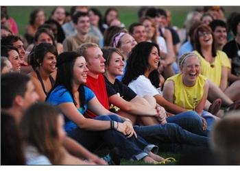 group of students sitting and laughing outdoors