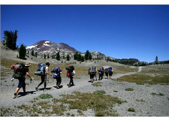 hikers with backpacks in a mountainous area