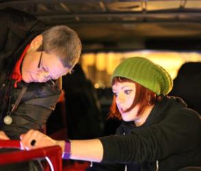 two people working on equipment at night