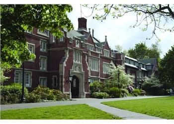 historic brick building surrounded by greenery