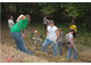 students engaged in outdoor cleanup