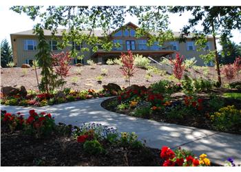 colorful garden path leading to a large house