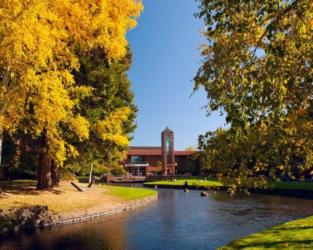 campus with a pond and fall foliage