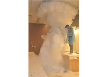 person in a cloud of vapor in a lab setting