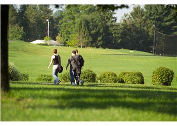 two students walking on campus grounds