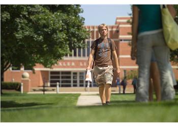 student walking near campus building