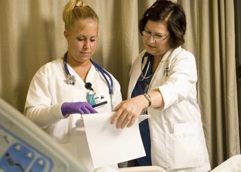 two medical professionals reviewing documents