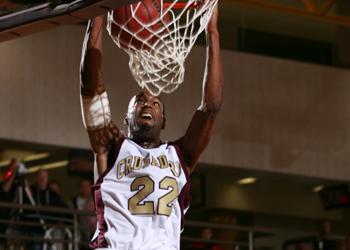 basketball player dunking the ball during game