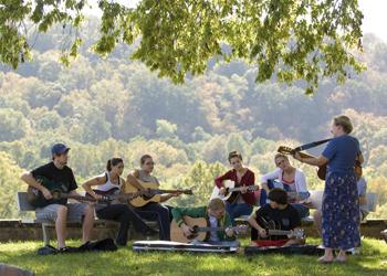 outdoor music class with students playing guitars