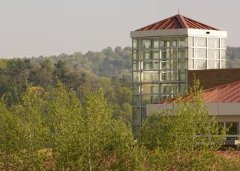 modern campus building surrounded by trees