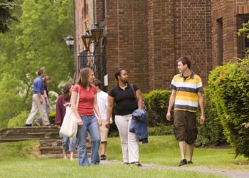 students walking and talking on campus path