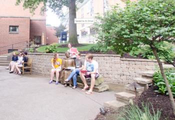 students sitting on steps outdoors