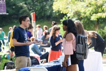 students interacting at an outdoor fair