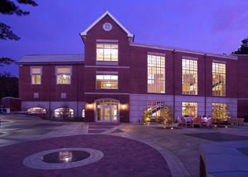 illuminated brick building at dusk