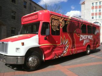 red campus shuttle bus with mascot graphics