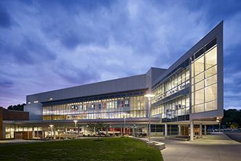 lit-up modern campus building at night