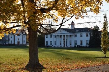 historic campus building with autumn leaves