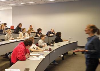 teacher in front of lecture room with students