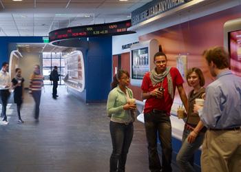 students conversing in a college cafe area