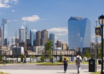 city skyline viewed from campus with walking students