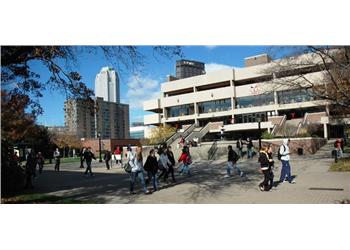 students walking in front of a campus building