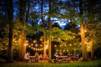 outdoor gathering area with fairy lights at dusk