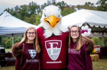 two students and mascot, text 'eastern university'