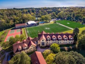 aerial view of campus buildings and sports field