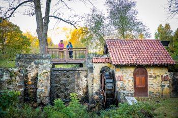 old waterwheel and viewing deck with visitors