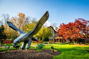 statue of bird with outstretched wings on campus