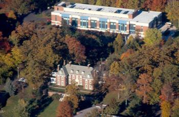 aerial shot of campus buildings amongst trees