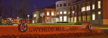 campus building at dusk with holiday wreaths