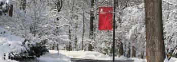 snow-covered campus with red banner