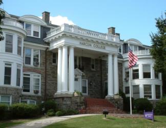 historic building with columns and 'harcum college' sign