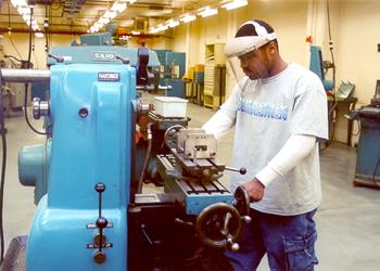 person operating machinery in a workshop