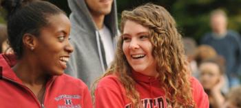 two students smiling wearing college hoodies