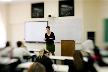 professor teaching in front of a whiteboard