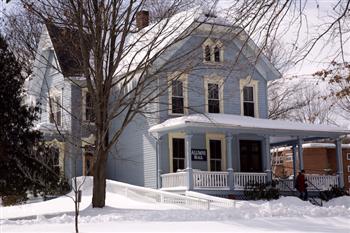 blue house surrounded by snow