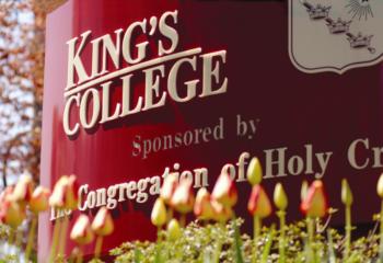 sign 'king's college' with tulips in foreground