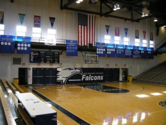 gymnasium with falcons logo and american flags