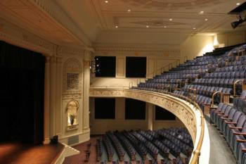 interior of a theater balcony with blue seats