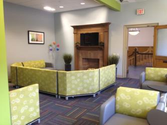 lounge area with fireplace and green sofas