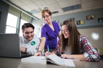 instructor and students with laptop in classroom