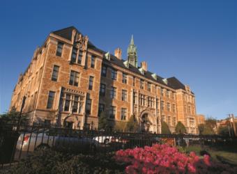 historic college building with blossoming flowers