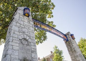 stone gateway with university emblem