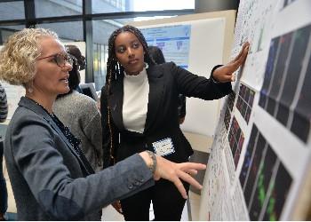 two people discussing a poster presentation