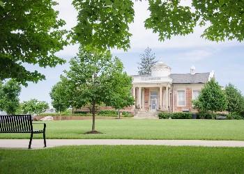 historical building with lawn and bench