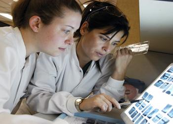 two students analyzing in a lab