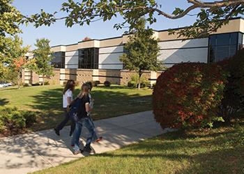 students walking outside science building